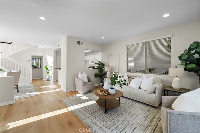 a living room with furniture and a potted plant