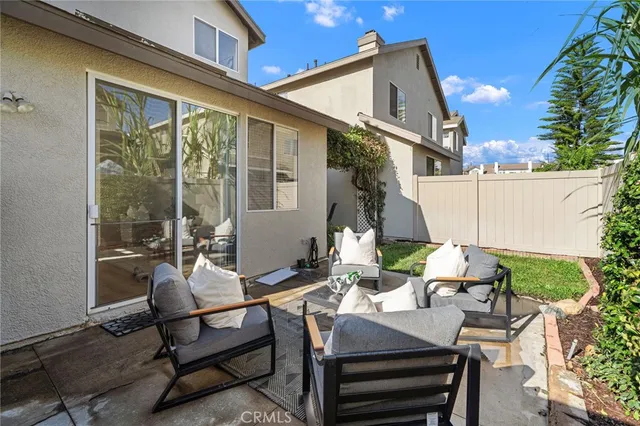 a view of a patio with table and chairs and potted plants