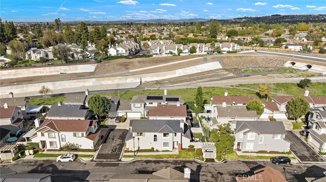 an aerial view of residential houses with outdoor space and ocean view