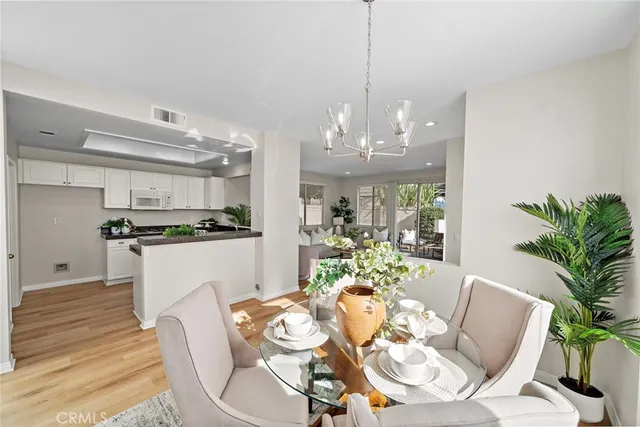 a view of a dining room with furniture kitchen and chandelier