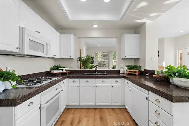 a kitchen with sink a stove and cabinets