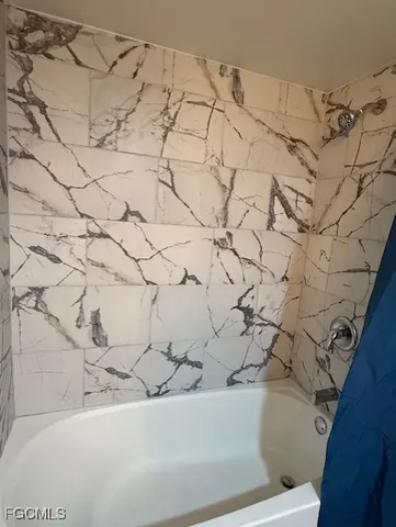 a white bath tub sitting in a bathroom