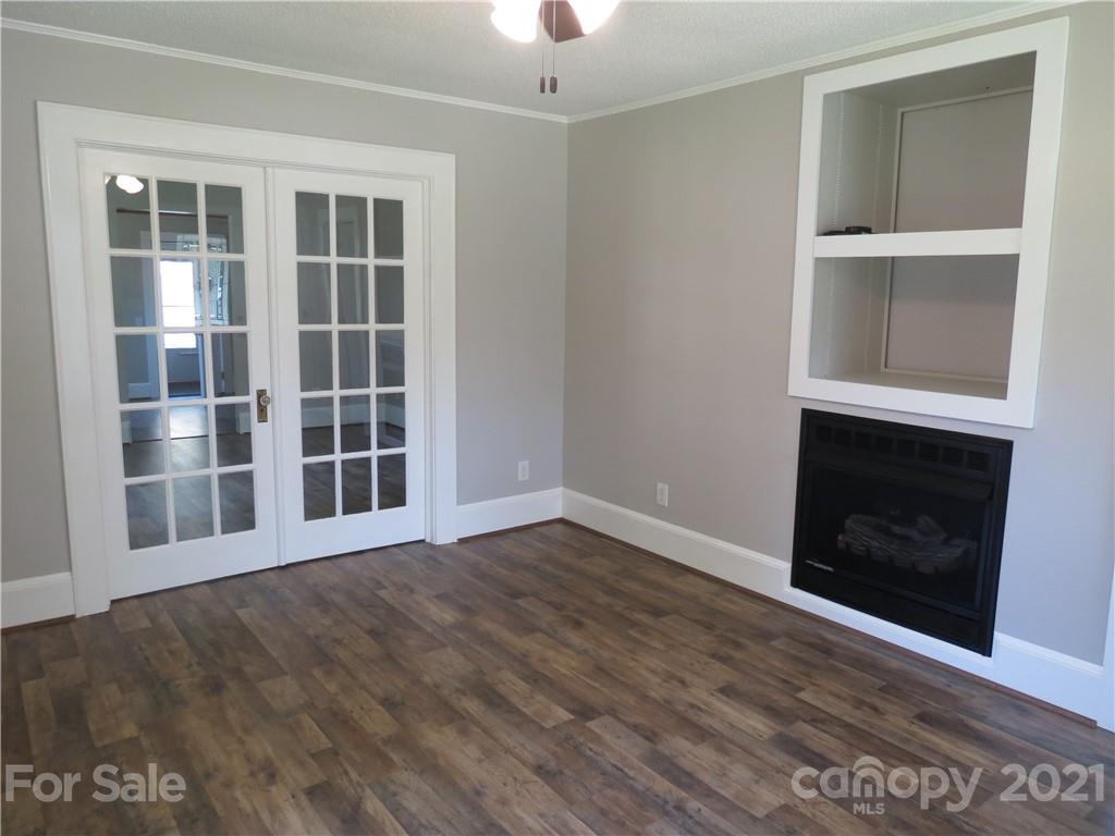 431 Union Cemetery Road Southwest Concord, NC 28027 - Photo 13 of 38 an empty room with windows and fireplace