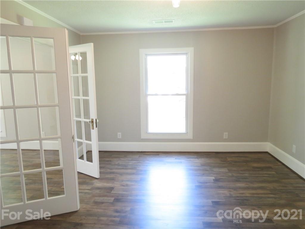 431 Union Cemetery Road Southwest Concord, NC 28027 - Photo 16 of 38 an empty room with wooden floor and windows