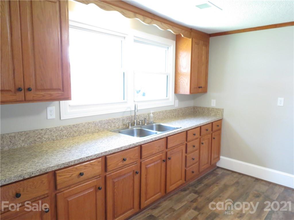 431 Union Cemetery Road Southwest Concord, NC 28027 - Photo 18 of 38 a kitchen with granite countertop a sink and a window