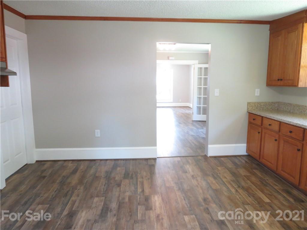 431 Union Cemetery Road Southwest Concord, NC 28027 - Photo 20 of 38 a view of a kitchen with wooden floor and cabinets