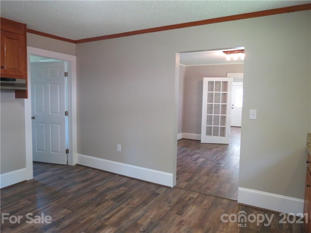 431 Union Cemetery Road Southwest Concord, NC 28027 - Photo 21 of 38 an empty room with wooden floor and windows