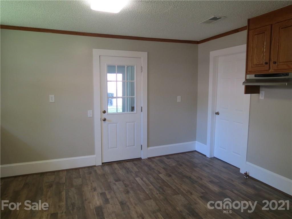 431 Union Cemetery Road Southwest Concord, NC 28027 - Photo 22 of 38 a view of an empty room with wooden floor and a cabinet