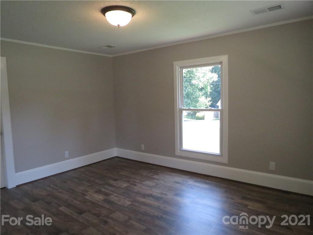 431 Union Cemetery Road Southwest Concord, NC 28027 - Photo 23 of 38 an empty room with wooden floor and windows