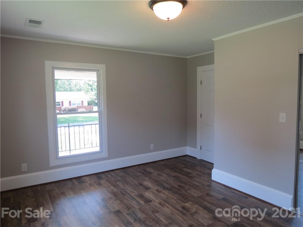 431 Union Cemetery Road Southwest Concord, NC 28027 - Photo 24 of 38 an empty room with wooden floor and windows