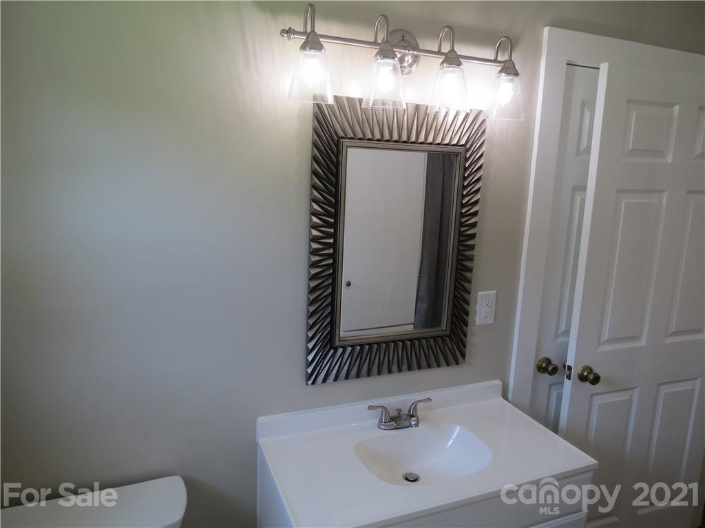 431 Union Cemetery Road Southwest Concord, NC 28027 - Photo 26 of 38 a bathroom with a sink and mirror