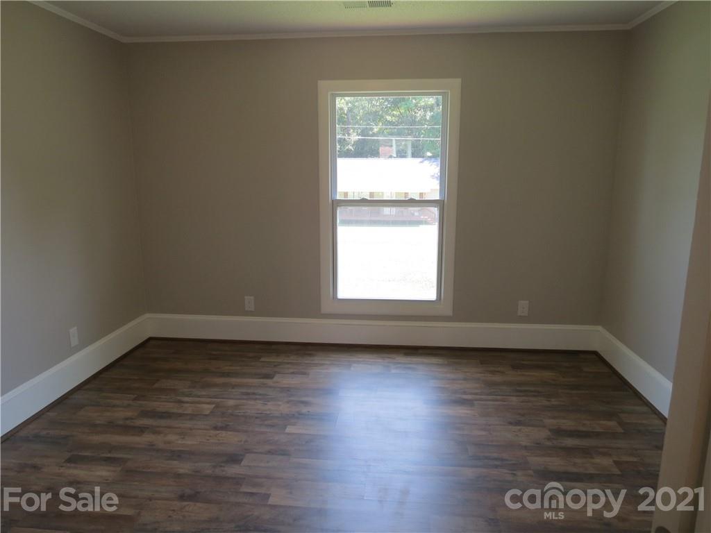 431 Union Cemetery Road Southwest Concord, NC 28027 - Photo 28 of 38 a view of an empty room with wooden floor and a window