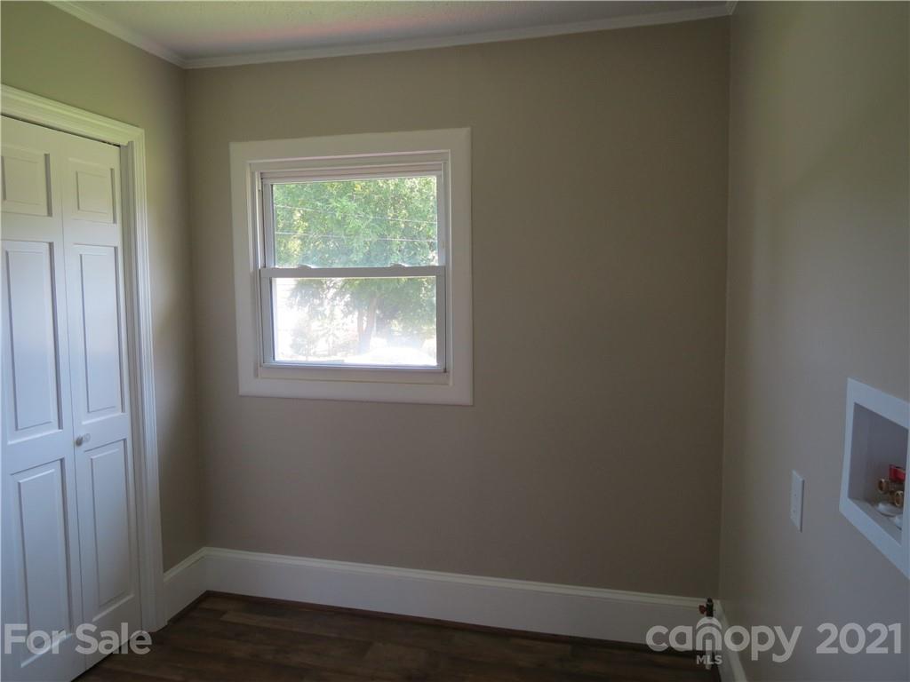 431 Union Cemetery Road Southwest Concord, NC 28027 - Photo 31 of 38 an empty room with wooden floor and windows