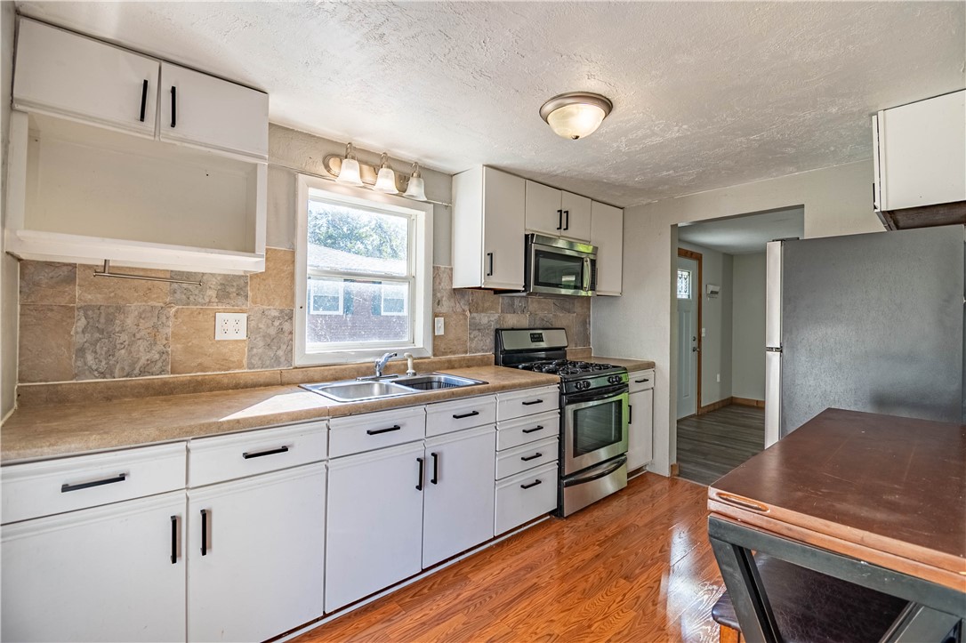 4016 Bayview Drive Decatur, IL 62521 - Photo 5 of 15 a kitchen with a sink stove and cabinets