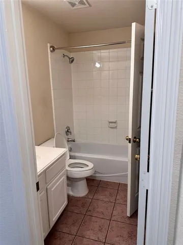 a bathroom with a toilet sink and shower