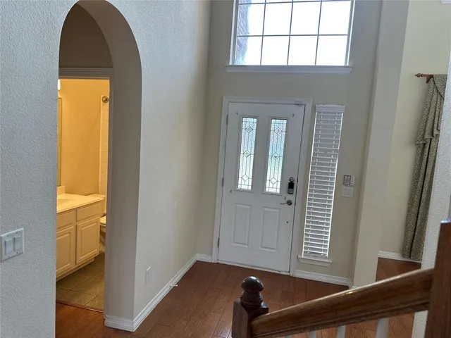 a view of a room that has a bed and a window in it