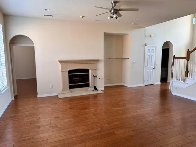 a view of an empty room with window and fire place