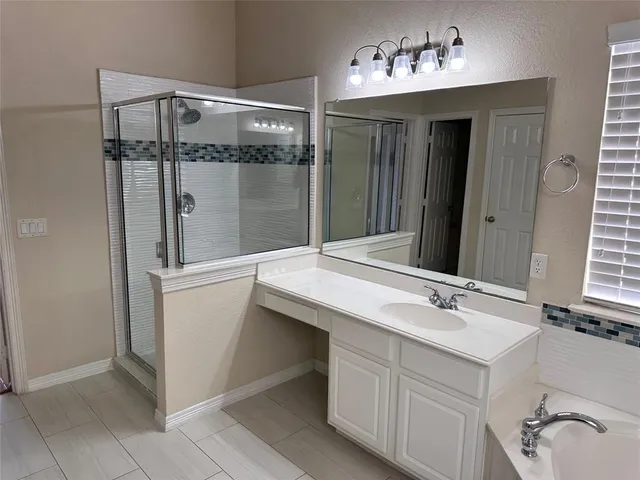 a bathroom with a sink and mirror