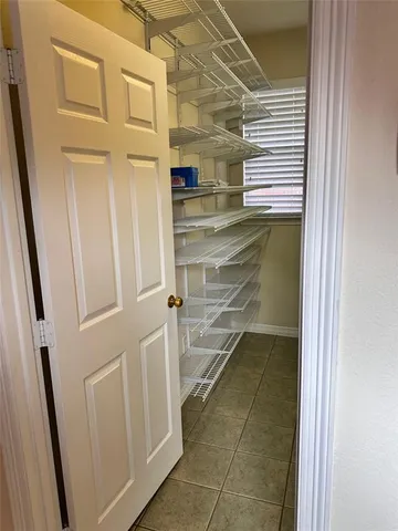a view of a backyard with plants and wooden fence