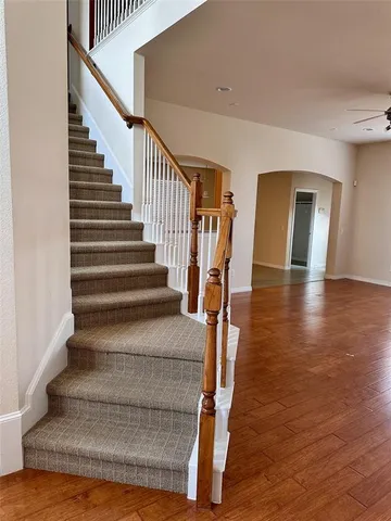 a view of staircase with white walls and railing