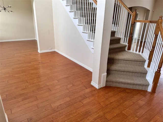an entryway in a hall with wooden floor