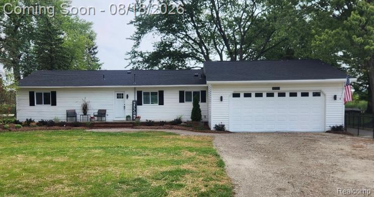 32563 Sutton Road New Baltimore, MI 48047 - Photo 1 of 43 White vinyl siding exterior with a dark shingle roof