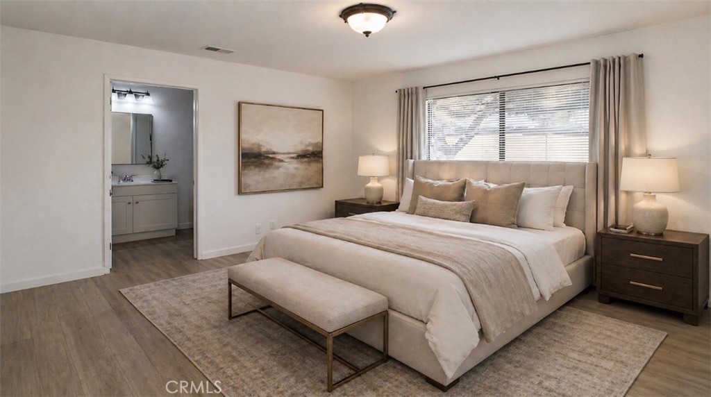 6736 Summit Valley Road Hesperia, CA 92345 - Photo 15 of 24 a bedroom with a bed and wooden floor