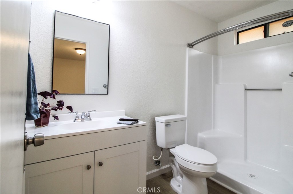 6736 Summit Valley Road Hesperia, CA 92345 - Photo 16 of 24 a bathroom with a sink toilet and mirror