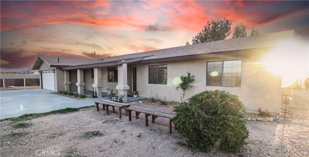 6736 Summit Valley Road Hesperia, CA 92345 - Photo 23 of 24 a view of a house with backyard sitting area and garden