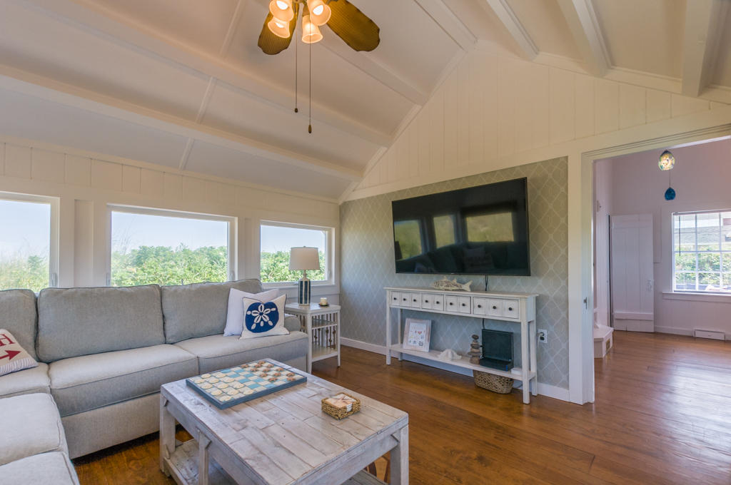 217 Phillips Road Sandwich, MA 02562 - Photo 9 of 37 a living room with furniture a flat screen tv and a fireplace