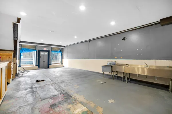 a hallway with a large window and furniture