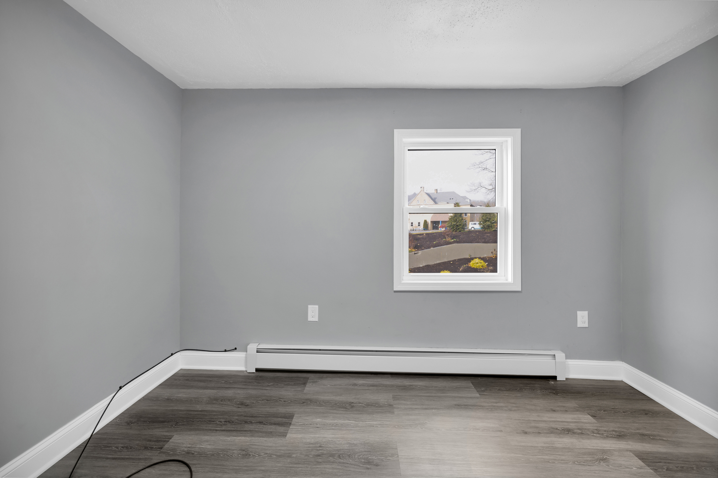 720 Main Street Winchester, CT 06098 - Photo 21 of 38 a view of an empty room with wooden floor and a window