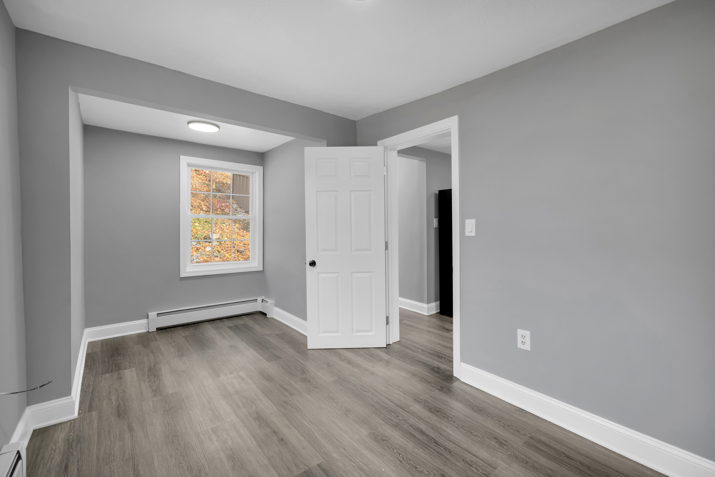 720 Main Street Winchester, CT 06098 - Photo 23 of 38 an empty room with wooden floor and windows