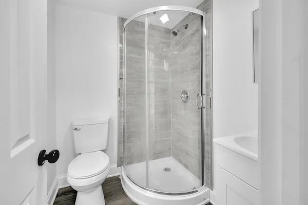 a bathroom with a toilet and a shower