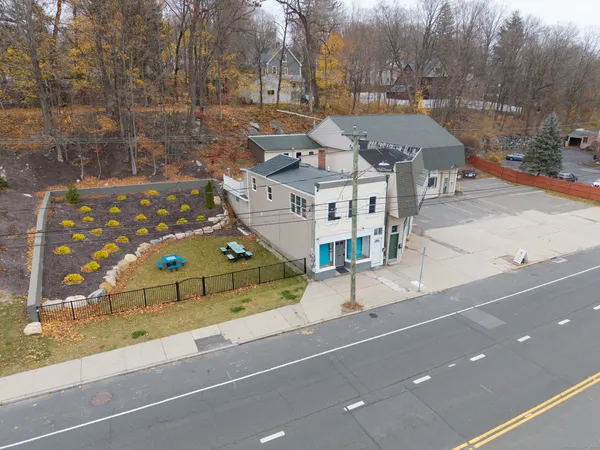 a view of a tennis ground with large trees