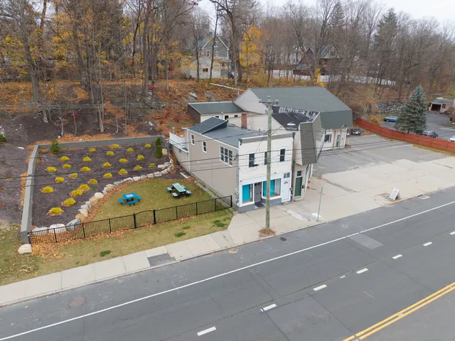 a view of a tennis ground with large trees