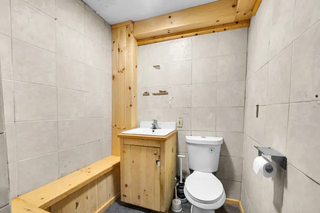 a bathroom with a toilet a sink and shower