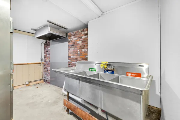 a kitchen with a sink a stove and cabinets