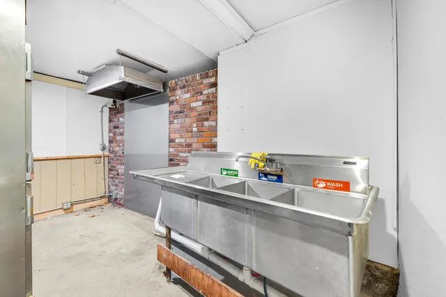 a kitchen with a sink a stove and cabinets