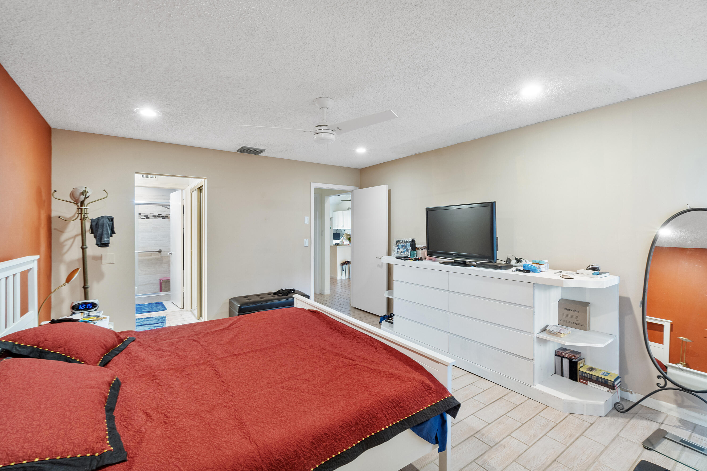 10900 Waterberry Court Boca Raton, FL 33498 - Photo 15 of 28 a bedroom with a bed and a flat screen tv