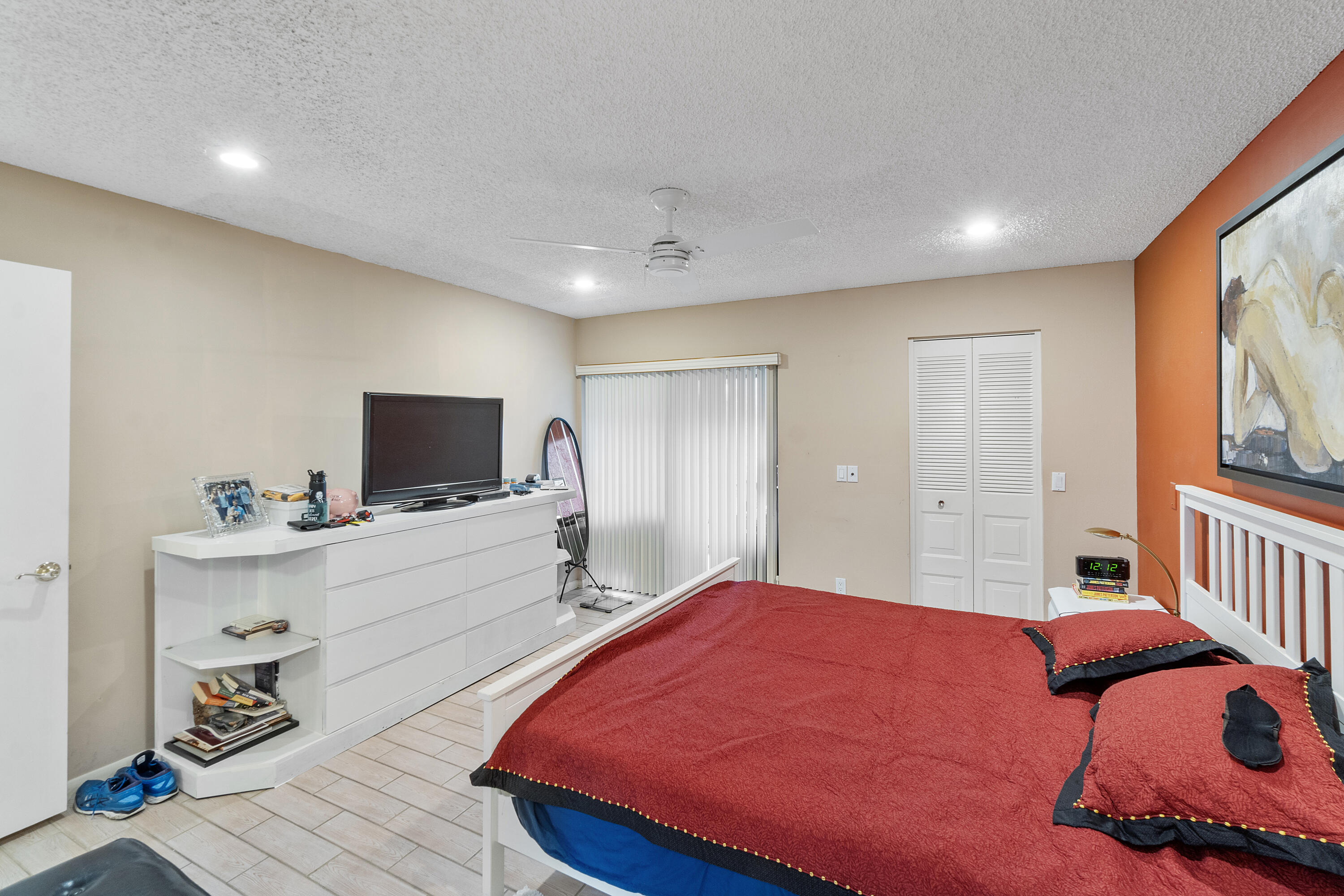 10900 Waterberry Court Boca Raton, FL 33498 - Photo 16 of 28 a bedroom with a bed and a flat screen tv