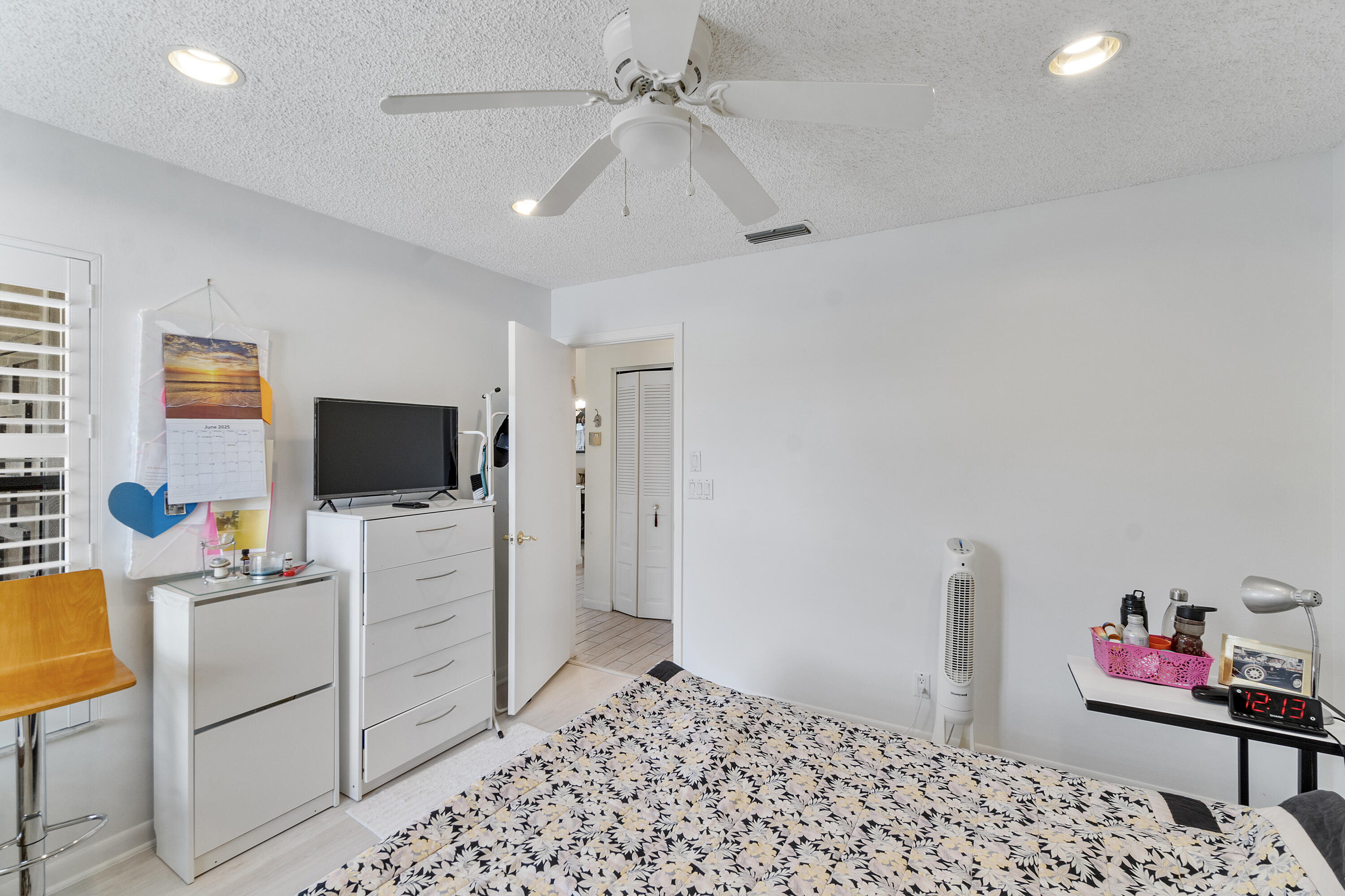 10900 Waterberry Court Boca Raton, FL 33498 - Photo 18 of 28 a bedroom with a bed and a flat screen tv