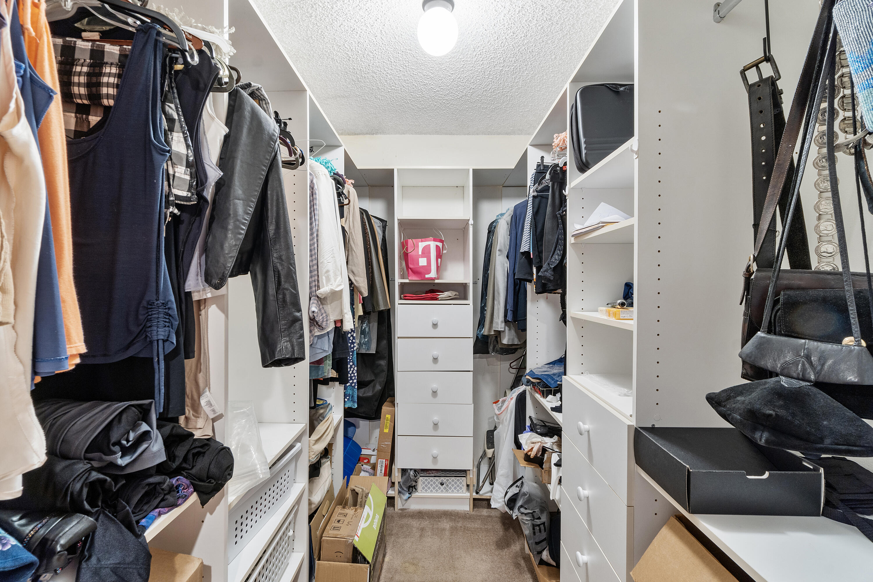 10900 Waterberry Court Boca Raton, FL 33498 - Photo 19 of 28 a view of walk in closet with clothes and shoes