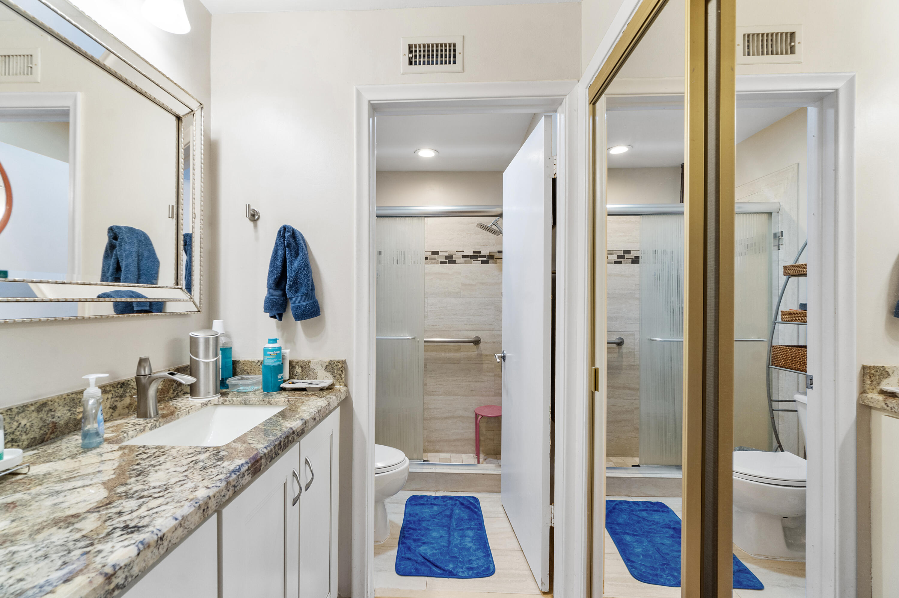 10900 Waterberry Court Boca Raton, FL 33498 - Photo 21 of 28 a bathroom with a granite countertop sink toilet and shower