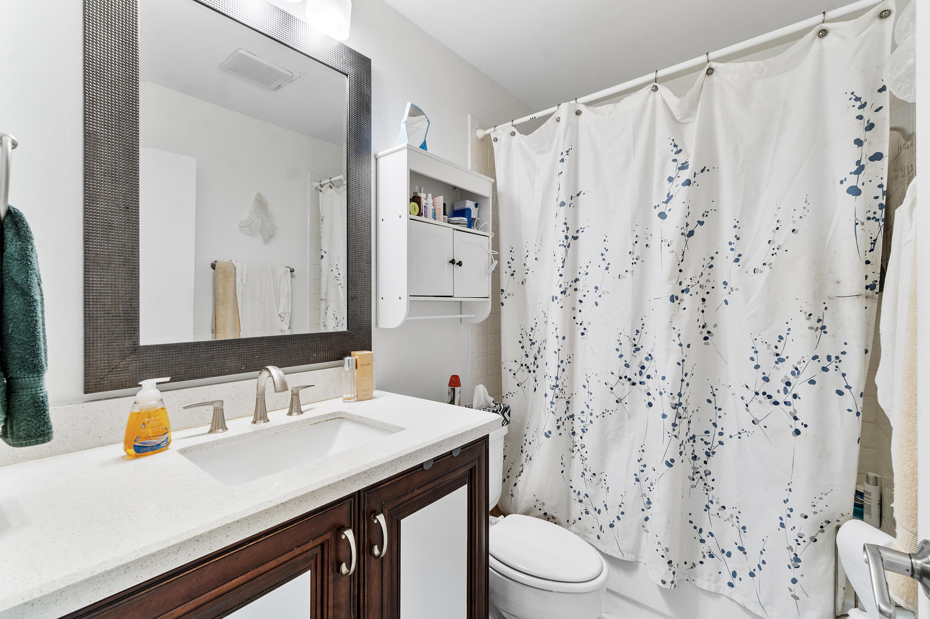 10900 Waterberry Court Boca Raton, FL 33498 - Photo 23 of 28 a bathroom with a sink a toilet and shower curtain