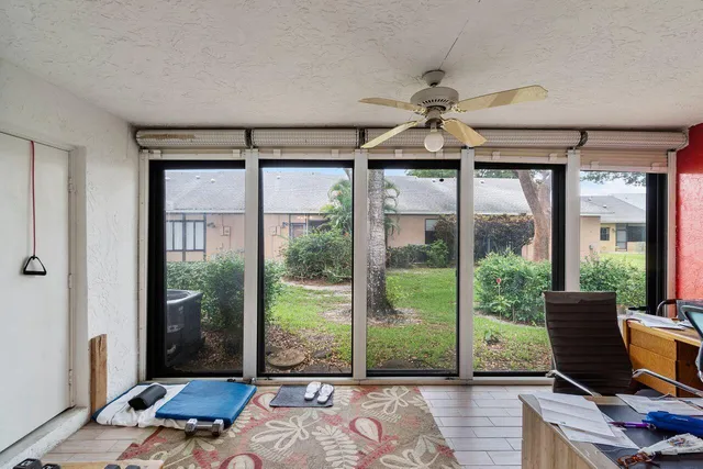 a living room with furniture and large windows