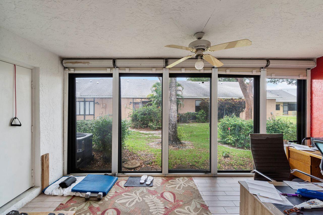 10900 Waterberry Court Boca Raton, FL 33498 - Photo 27 of 28 a living room with furniture and large windows