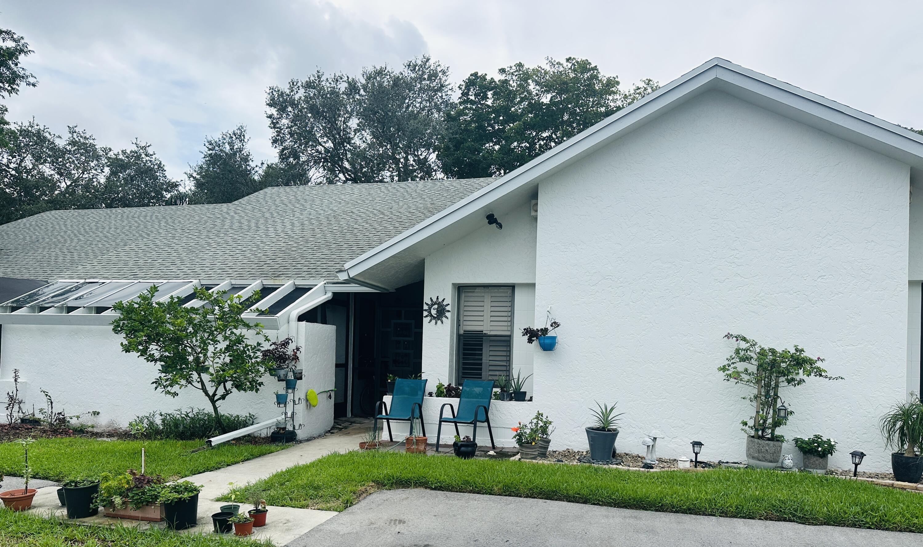 10900 Waterberry Court Boca Raton, FL 33498 - Photo 3 of 28 a front view of a house with garden