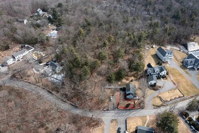 an aerial view of a house with yard and outdoor seating