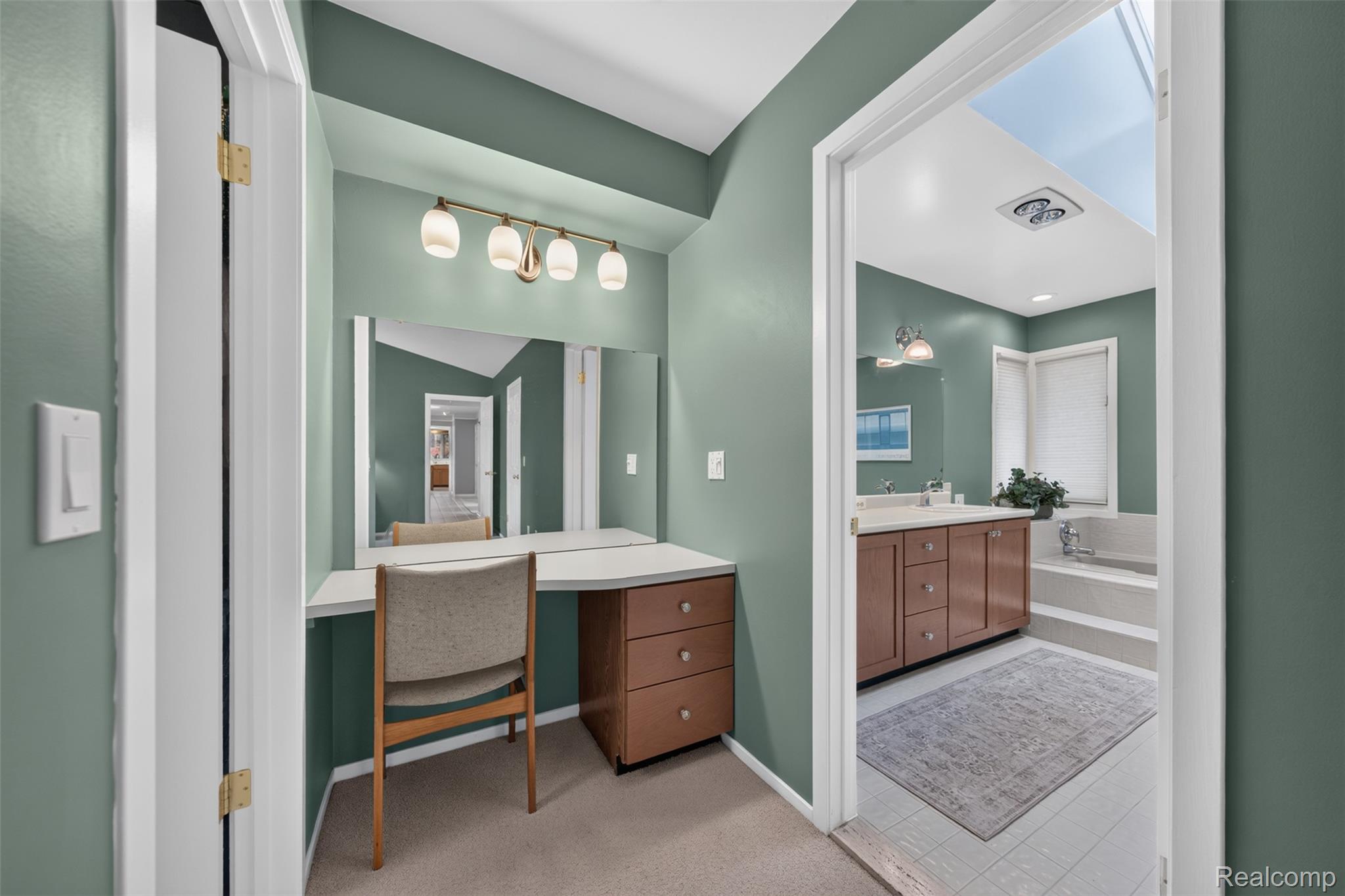 1236 Chaffer Drive Rochester, MI 48306 - Photo 31 of 76 Built-in vanity with a large mirror and brass-finish lighting fixture